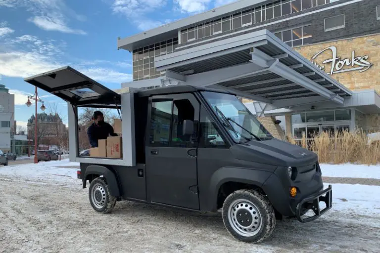electric utility vehicle delivering packages